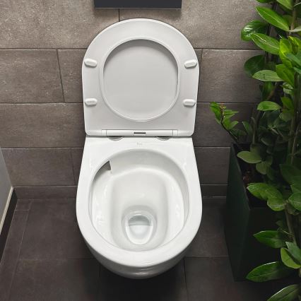 REA-C1259 - Zidna WC školjka s WC sjedalom CARLO MINI TORNADO RIMLESS keramika/sjajna bijela